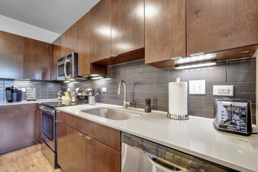 Fully equipped kitchen with stainless appliances and quartz countertops