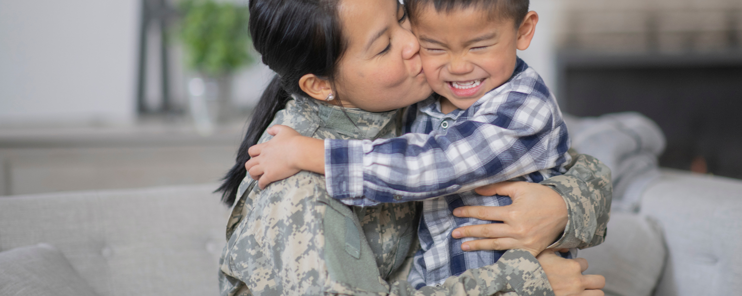 military woman hugging her son